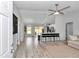 Open-concept living area features modern ceiling fan, kitchen island and plank flooring throughout at 16848 Sw 41St Avenue Rd, Ocala, FL 34473
