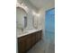 Bathroom showcasing a dual sink vanity with modern fixtures and ample cabinet space at 18890 Sw 60Th St, Dunnellon, FL 34432