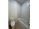 Modern bathroom featuring a toilet, bathtub and unique tiling at 18890 Sw 60Th St, Dunnellon, FL 34432
