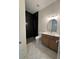 Bathroom with shower, toilet, vanity, wood floors, and unique tile at 18890 Sw 60Th St, Dunnellon, FL 34432