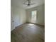 Neutral bedroom with wood flooring and an outdoor view from the window at 18890 Sw 60Th St, Dunnellon, FL 34432
