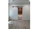 Bright bedroom showcasing light wood floors and a sliding barn door leading to the bathroom at 18890 Sw 60Th St, Dunnellon, FL 34432