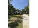 Scenic view of a charming home surrounded by mature trees and a winding driveway at 18890 Sw 60Th St, Dunnellon, FL 34432