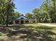 Charming home nestled among trees with a well-manicured lawn and covered porch at 18890 Sw 60Th St, Dunnellon, FL 34432