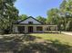 Charming single-story home with modern farmhouse design, lush lawn, and inviting covered porch at 18890 Sw 60Th St, Dunnellon, FL 34432