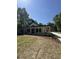 Home with lush landscaping, covered front porch, modern farmhouse style, and long driveway at 18890 Sw 60Th St, Dunnellon, FL 34432