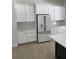 Modern kitchen with white cabinets, a refrigerator, and beautiful gold hardware at 18890 Sw 60Th St, Dunnellon, FL 34432