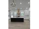 Modern kitchen boasts an island, white cabinetry, a statement range hood, and abundant natural light at 18890 Sw 60Th St, Dunnellon, FL 34432
