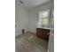 A bright laundry room featuring wood floors, wooden cabinets and a sink at 18890 Sw 60Th St, Dunnellon, FL 34432
