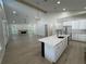 Bright, open-concept living room with a fireplace, wood-look floors, and an island bar overlooking the yard at 18890 Sw 60Th St, Dunnellon, FL 34432