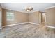 A spacious bedroom featuring tile floors, crown moulding, neutral paint and a view into the Primary bath at 19300 Sw 60Th St, Dunnellon, FL 34432