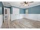 Bedroom with wainscoting, neutral-toned walls, a ceiling fan and plenty of closet space at 19300 Sw 60Th St, Dunnellon, FL 34432