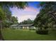 Charming single-story home with mature trees, landscaped lawn, and a serene, picturesque setting at sunset at 19300 Sw 60Th St, Dunnellon, FL 34432