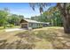 Charming single-story home with a stone facade, metal roof, attached garage, and a spacious front yard at 19300 Sw 60Th St, Dunnellon, FL 34432