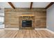 A stylish fireplace is accented by stacked stone and a rustic mantel, set against a wood paneled wall at 19300 Sw 60Th St, Dunnellon, FL 34432