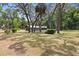 Spacious front yard featuring mature trees and lush landscaping, offering a serene and private setting at 19300 Sw 60Th St, Dunnellon, FL 34432