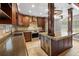 Kitchen featuring custom cabinetry, stainless steel appliances, and a unique island with a rustic wood design at 19300 Sw 60Th St, Dunnellon, FL 34432