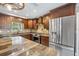Stunning kitchen with stainless steel appliances, custom cabinetry, and a large center island at 19300 Sw 60Th St, Dunnellon, FL 34432