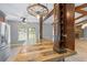 Charming kitchen boasts an island with custom post shelving, pendant lighting and stainless steel appliances at 19300 Sw 60Th St, Dunnellon, FL 34432