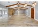 Spacious living room featuring vaulted ceilings with exposed beams, wood burning fireplace, and lots of natural light at 19300 Sw 60Th St, Dunnellon, FL 34432