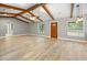 Bright living room boasting beautiful wood-look tile floors, wooden ceiling beams, and a warm, welcoming atmosphere at 19300 Sw 60Th St, Dunnellon, FL 34432