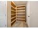 Spacious pantry room with ample shelving space, wood-look floors, and white trim at 19300 Sw 60Th St, Dunnellon, FL 34432