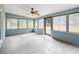 Bright sun room with large windows and ceiling fan perfect for relaxing and entertaining at 19300 Sw 60Th St, Dunnellon, FL 34432