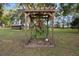 Backyard arbor with mature staghorn fern creating a beautiful outdoor space at 19300 Sw 60Th St, Dunnellon, FL 34432