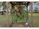 Mature staghorn fern hanging inside of backyard arbor creates a stunning display at 19300 Sw 60Th St, Dunnellon, FL 34432