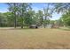 Large grassy backyard featuring shady trees, two storage sheds, and lots of space at 19300 Sw 60Th St, Dunnellon, FL 34432