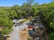 Spacious property featuring a house, parking area, and river access amidst lush greenery and mature trees at 19395 Sw 100Th Loop, Dunnellon, FL 34432
