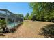 Large backyard with a screened-in pool area and a spacious grassy area at 19395 Sw 100Th Loop, Dunnellon, FL 34432