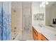 Bright bathroom featuring a vanity with ample counter space and a shower-tub combo at 19395 Sw 100Th Loop, Dunnellon, FL 34432
