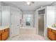 Large bathroom featuring a garden tub, glass-enclosed shower, and and sinks at 19395 Sw 100Th Loop, Dunnellon, FL 34432