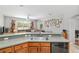 Open kitchen with gray countertops, ample cabinet space, and view into living room at 19395 Sw 100Th Loop, Dunnellon, FL 34432