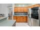 Kitchen area boasting wooden cabinetry and stainless steel refrigerator at 19395 Sw 100Th Loop, Dunnellon, FL 34432