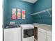 Tidy laundry room with side by side machines, countertop, and cabinet storage at 19395 Sw 100Th Loop, Dunnellon, FL 34432