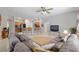 Open-concept living room with tile floors and views into the kitchen area with modern appliances at 19395 Sw 100Th Loop, Dunnellon, FL 34432