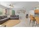 Bright and airy living room with an open layout, tile flooring, breakfast bar, and comfortable seating area at 19395 Sw 100Th Loop, Dunnellon, FL 34432