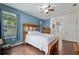 Bright bedroom with wooden furniture, tile floors, and a ceiling fan at 19395 Sw 100Th Loop, Dunnellon, FL 34432