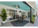 Inviting covered patio with a ceiling fan, outdoor seating, and views of the pool area through sliding glass doors at 19395 Sw 100Th Loop, Dunnellon, FL 34432
