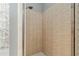 Shower with tan tiles and clear glass door, adjacent to the bathtub at 19395 Sw 100Th Loop, Dunnellon, FL 34432
