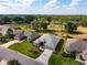 This aerial view highlights landscaping, golf course, and charming single-story homes at 2008 Palo Alto Ave, The Villages, FL 32159