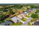 An aerial view of the neighborhood showcasing homes with mature trees and a golf course in the backyard at 2008 Palo Alto Ave, The Villages, FL 32159
