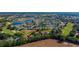A beautiful aerial view of homes surrounding a golf course with a pond at the center of the neighborhood at 2008 Palo Alto Ave, The Villages, FL 32159