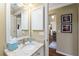 Bathroom featuring granite countertop, white cabinets, and a mirror with a white frame at 2008 Palo Alto Ave, The Villages, FL 32159