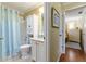 Bathroom view featuring a toilet, vanity with granite countertop, and a shower with a light blue curtain at 2008 Palo Alto Ave, The Villages, FL 32159