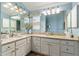 Well-lit bathroom featuring dual sinks, granite countertops, and a decorative mirror at 2008 Palo Alto Ave, The Villages, FL 32159