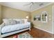 Charming bedroom featuring a daybed with decorative pillows and a colorful rug on wood floors at 2008 Palo Alto Ave, The Villages, FL 32159