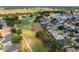 Aerial view of homes and community, near green golf course, with some water views at 2008 Palo Alto Ave, The Villages, FL 32159